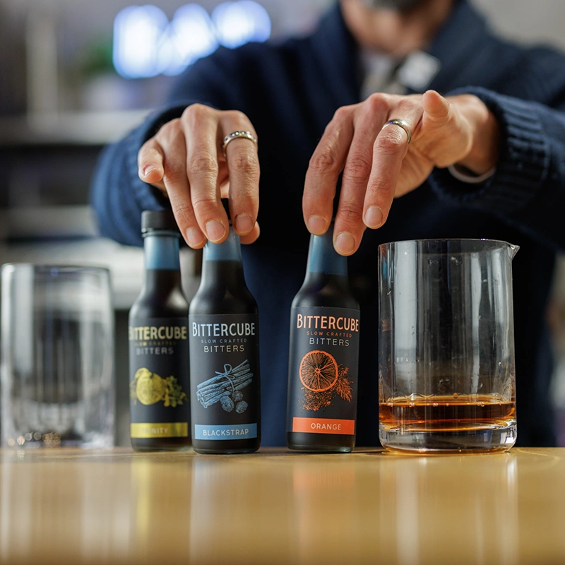 Product shot of a mixologist using Bittercube Bitters