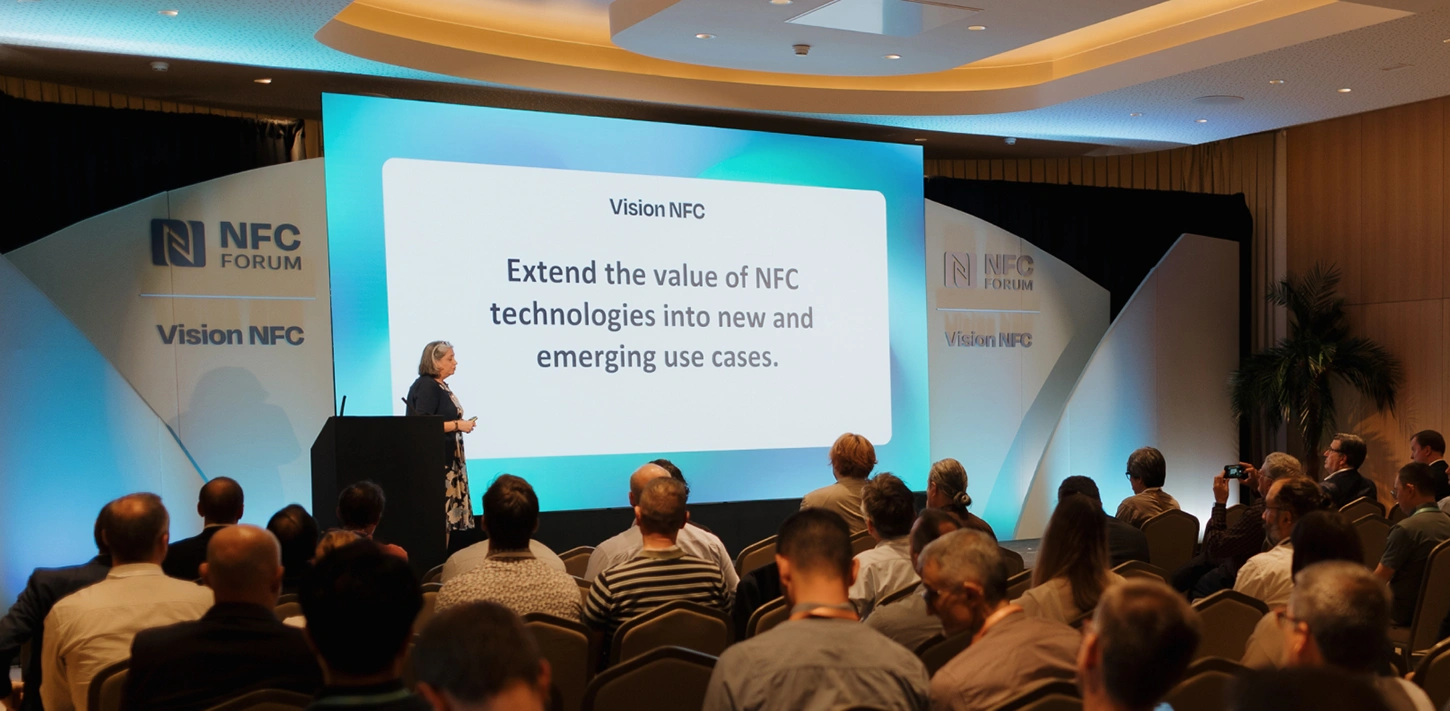 A speaker on stage at the NFC Forum