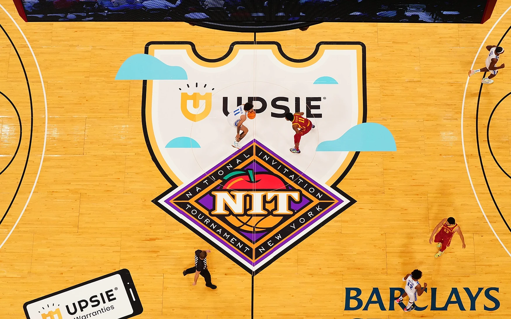 Basketball court with Upsie logo on the floor at center court.