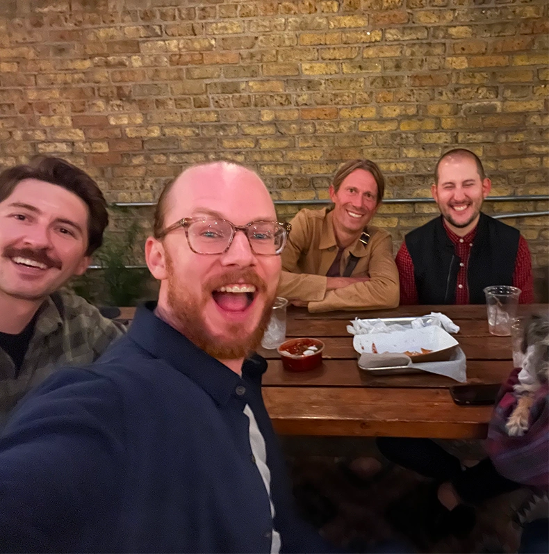Chris, Nick, Adam, and Michael smile for selfie