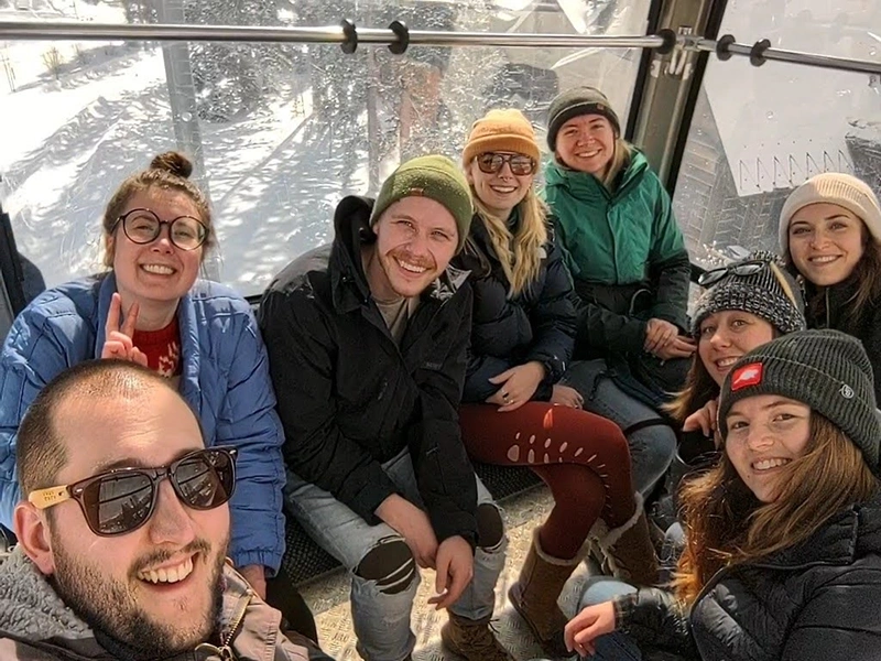 The crew, in a gondala on their way to a hike